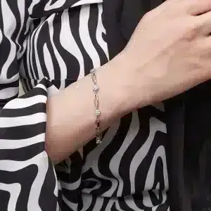 دستبند زنانه نگین دار طرح بیضی و گل ژوپینگ مدل XUPING 4646 وکسوز